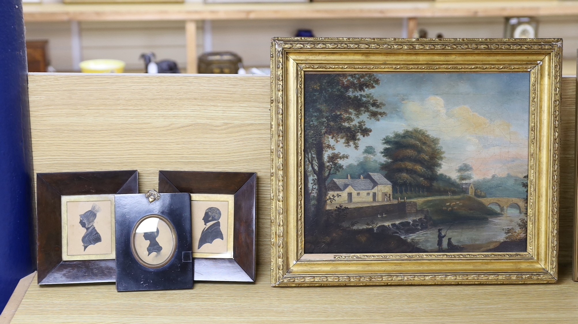 Irish School, 19th century, oil on canvas, Figures angling amongst a rural village, provenance verso, 30 x 37cm, together with three related silhouettes of the family who lived in the subject house